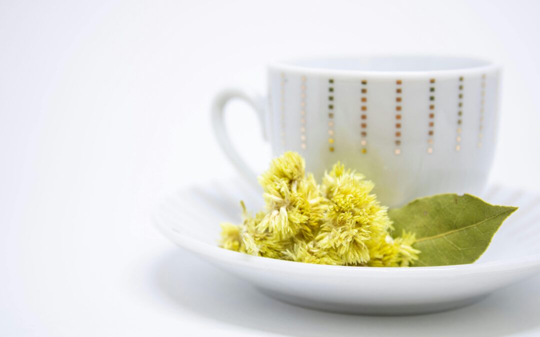 A minimalist teacup with yellow flowers and a leaf, perfect for zen and relaxation themes.